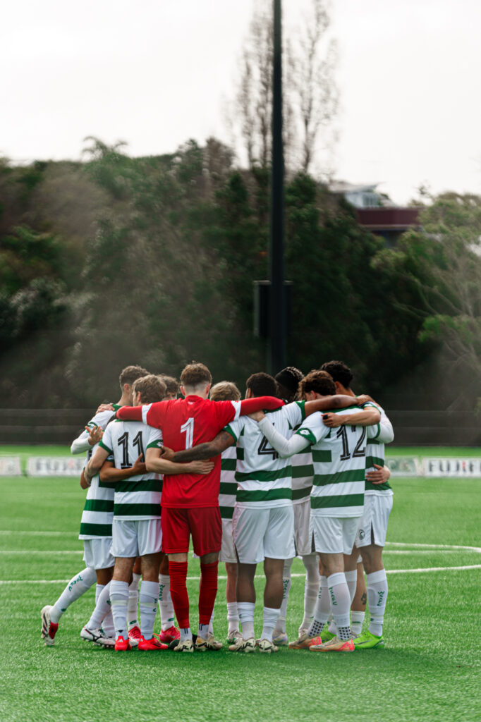 Western Springs FC players huddle before a football match.