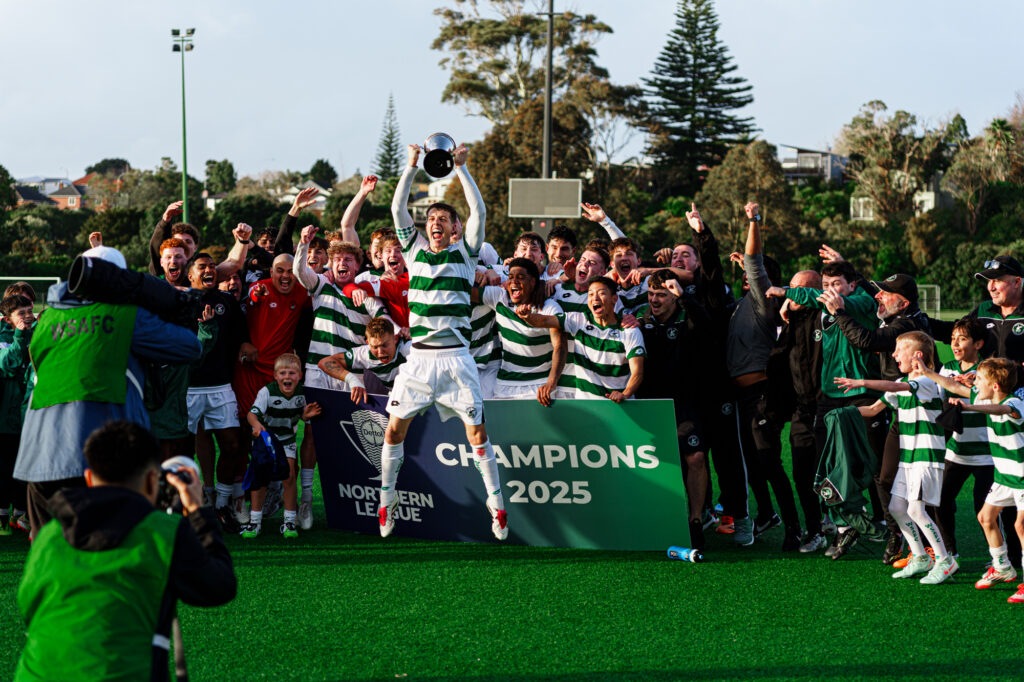 Western Springs FC Premier mens football team raise the trophy and cheer to celebrate winning the 2025 Dettol Northern League in New Zealand.